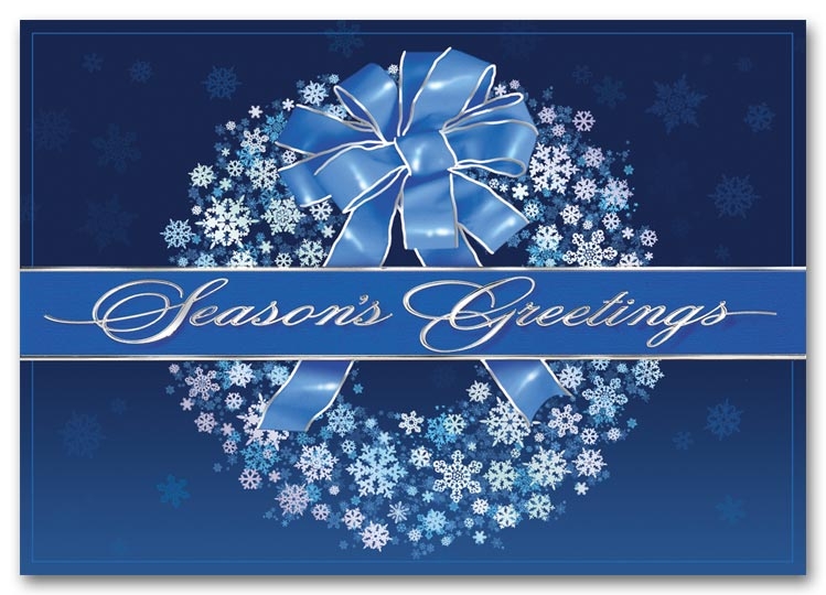 Holiday cards with a silver wreath on a blue background. 