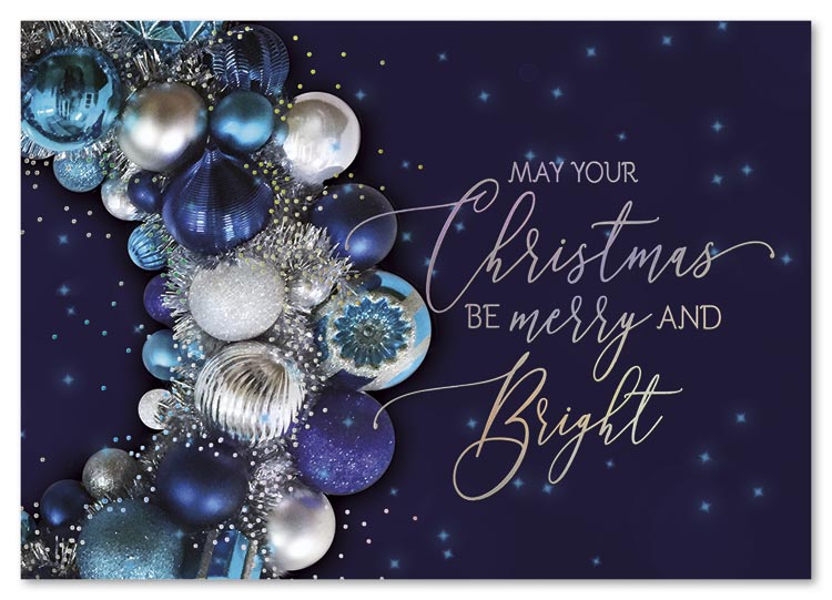 A stunning wreath of holiday baubles floats across a magical night sky in the Brite Shine Christmas Card.
