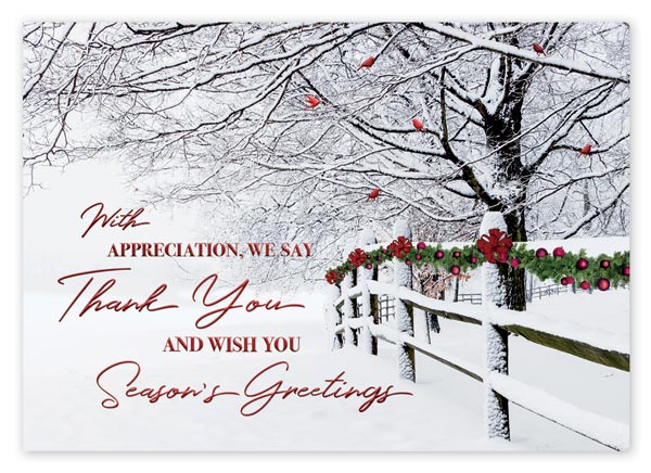 An evergreen garland along a snow dusted fence shows the way home on the Winter Wishes holiday card.